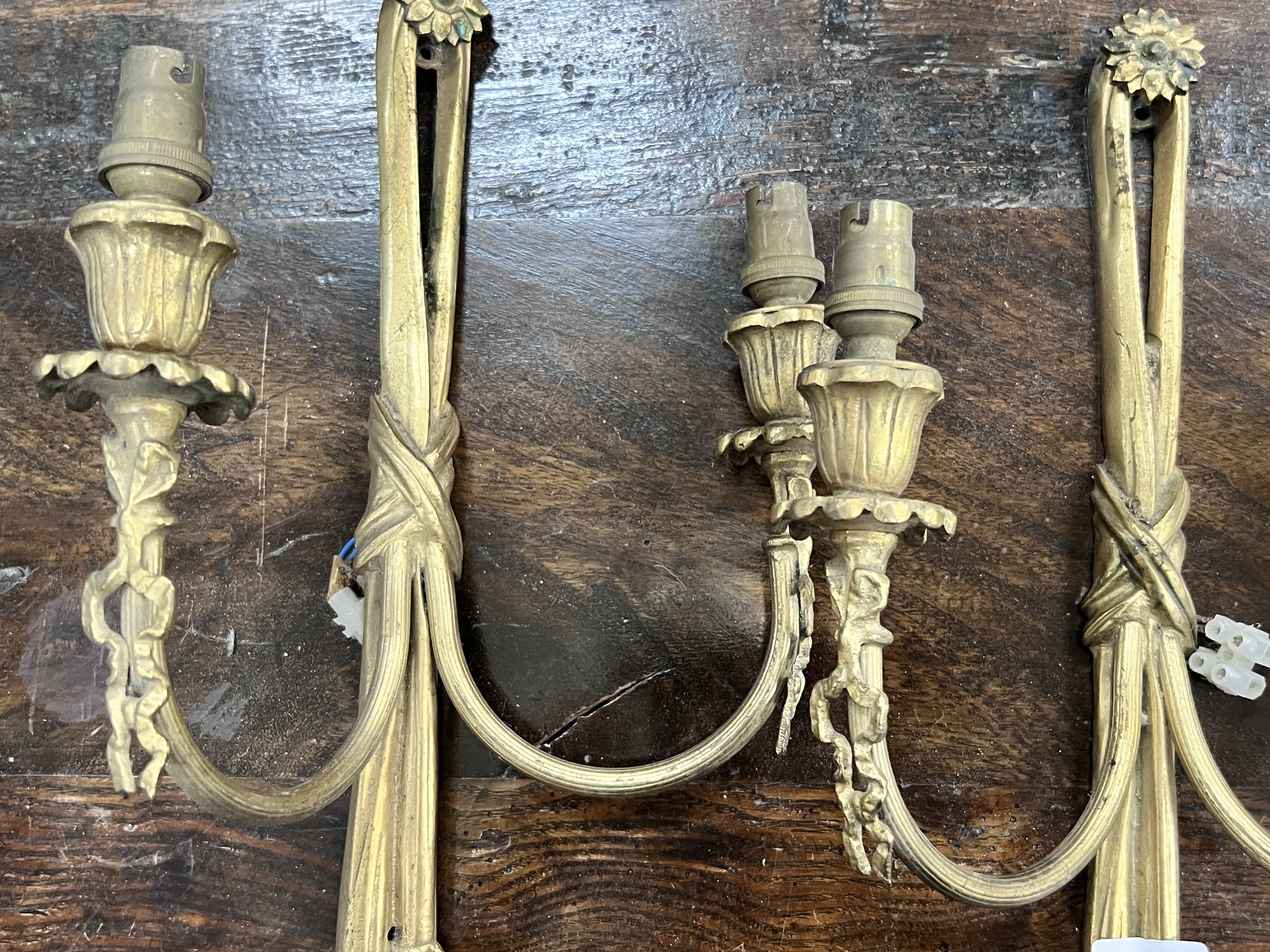 Five (three plus two) assorted gilt metal wall lights